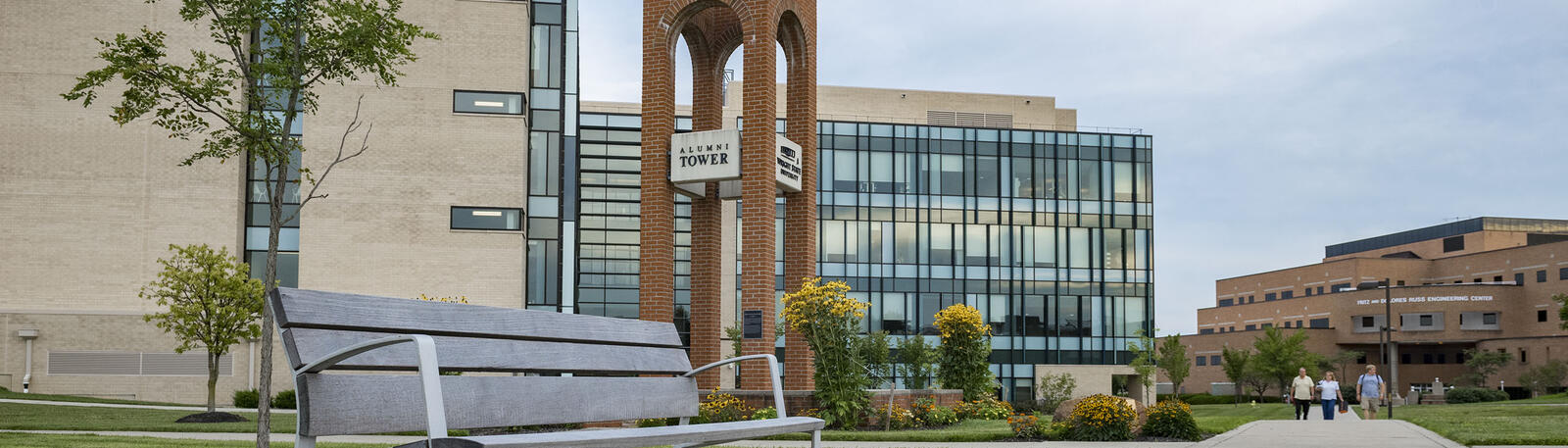 photo of a bench, alumni tower, and the nec building on wright state's campus